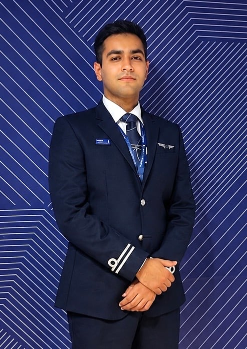 Pranit Badhwar in airline pilot uniform, wings and epaulettes visible.