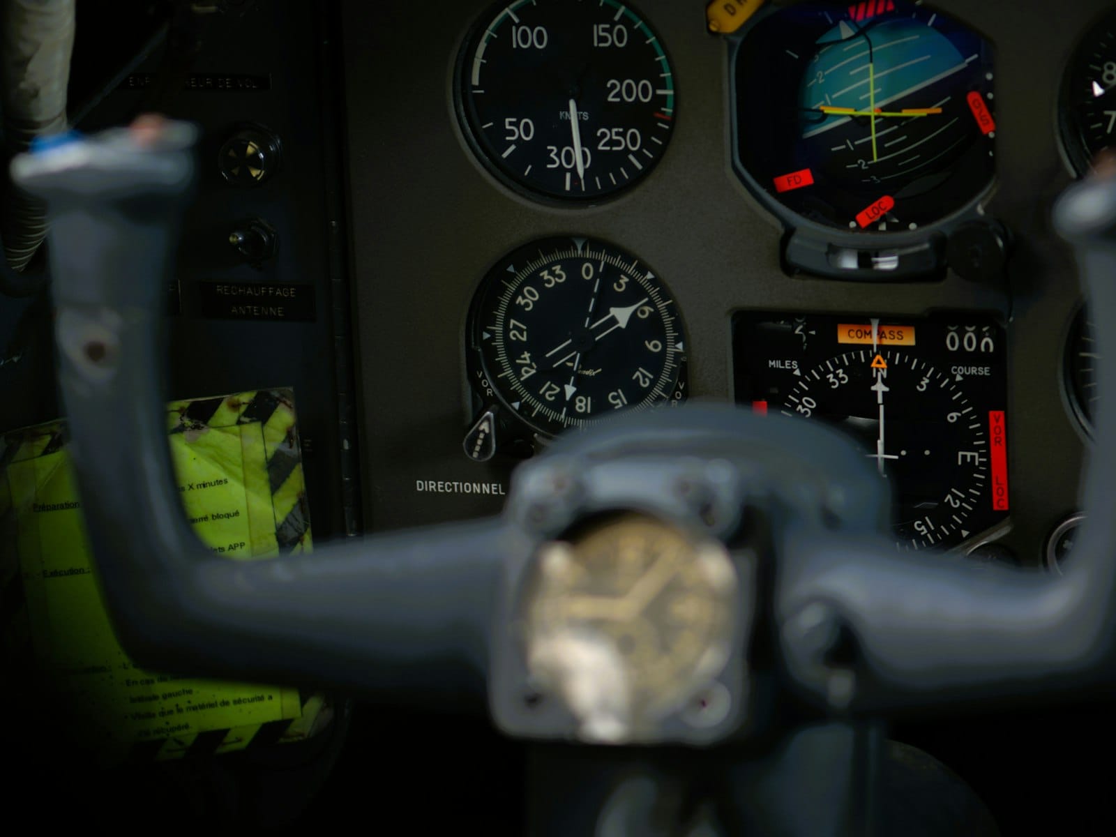 Analog flight instruments glowing amber at night